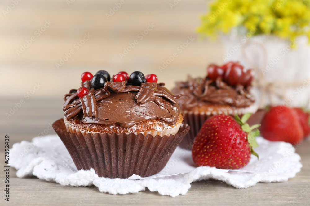 Tasty cupcakes on wooden background