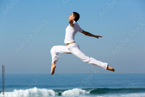 young woman dancing on beach