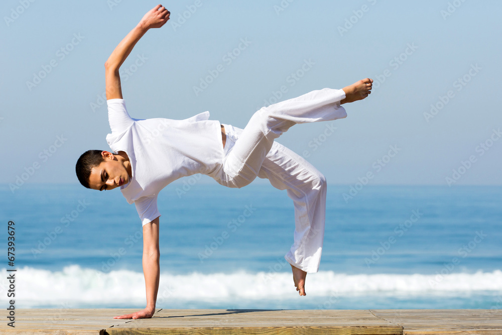 Fototapeta premium young woman practicing capoeira