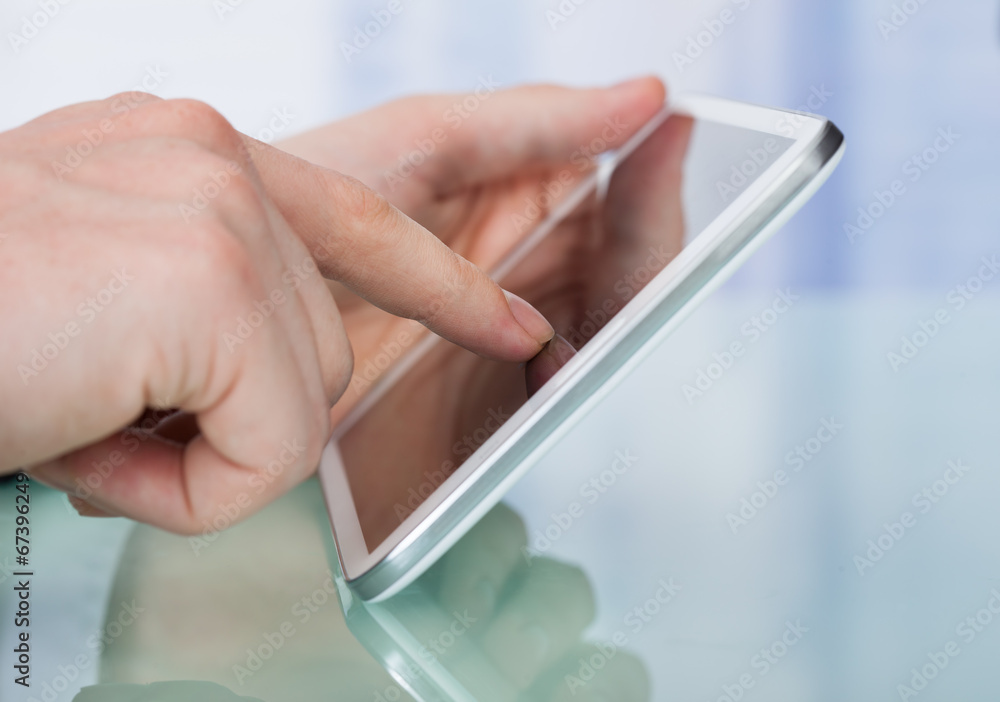 Businessman Using Digital Tablet In Office