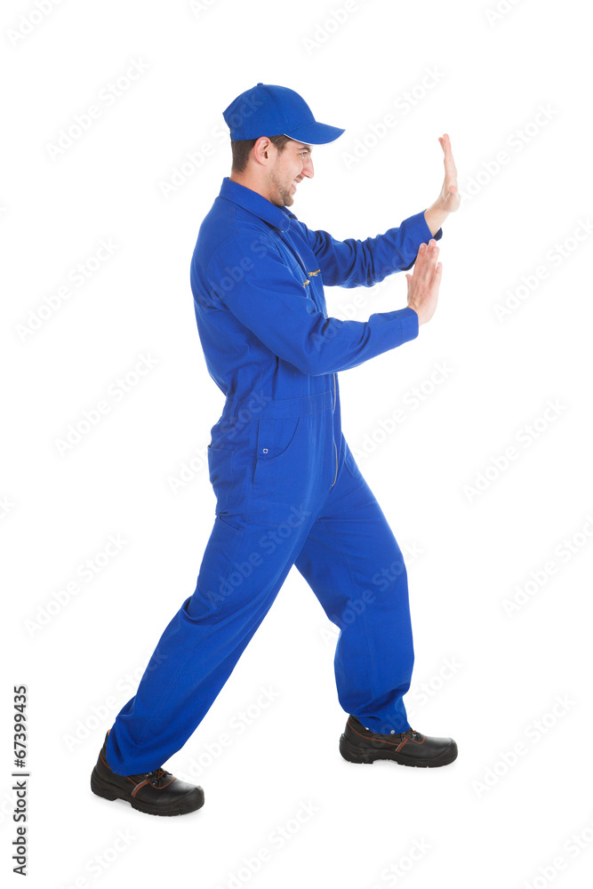 Confident Young Male Worker Pushing Empty Space Confident Young Male Worker Pushing Empty Space