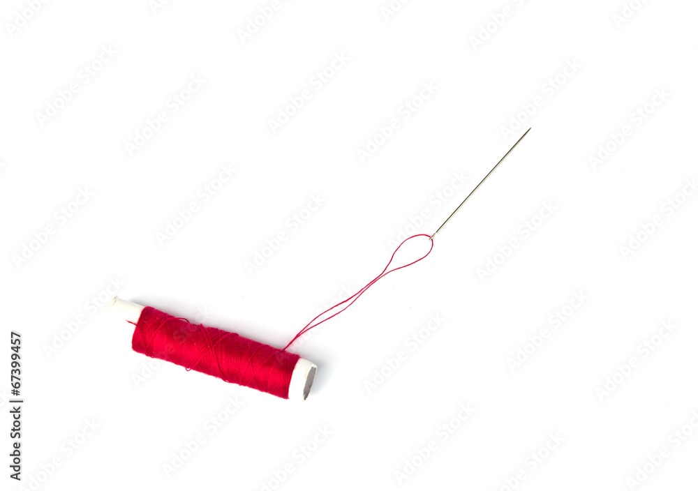 Red thread and needle on white Red thread and needle on white