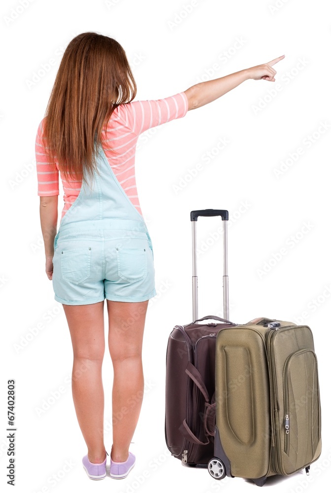 Back view of traveling pointing woman with suitcase Back view of traveling pointing woman with suitcase