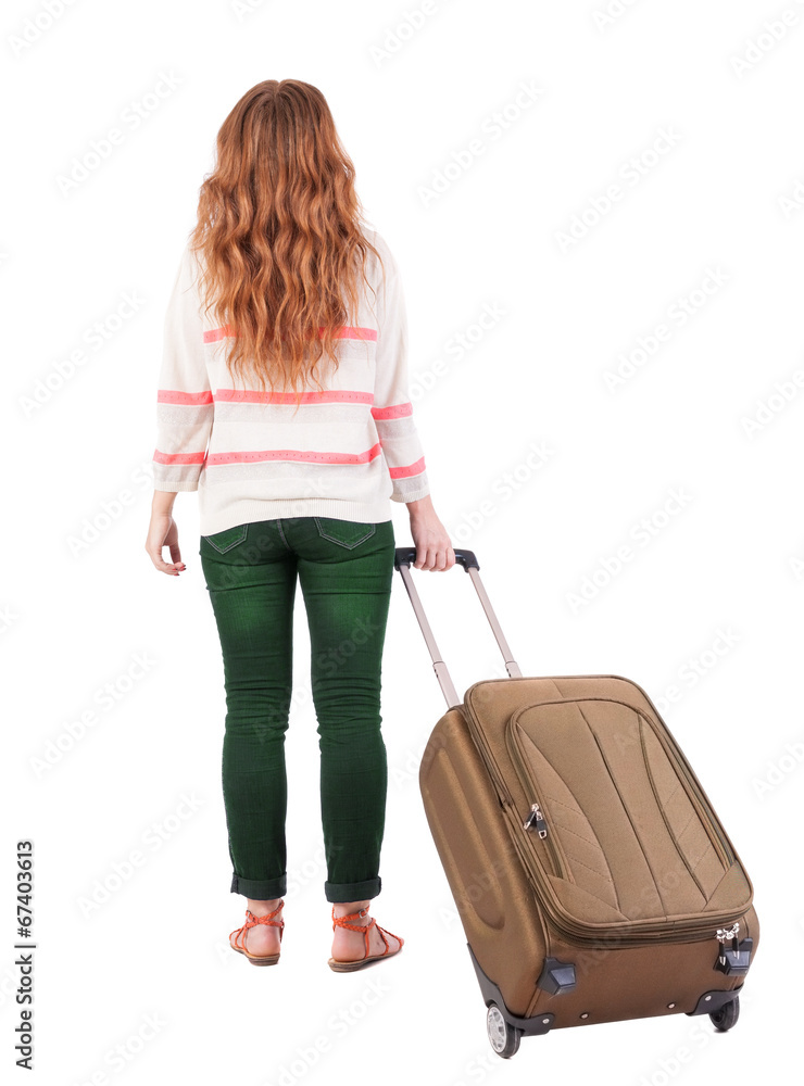 back view of walking woman with suitcase. back view of walking woman with suitcase.