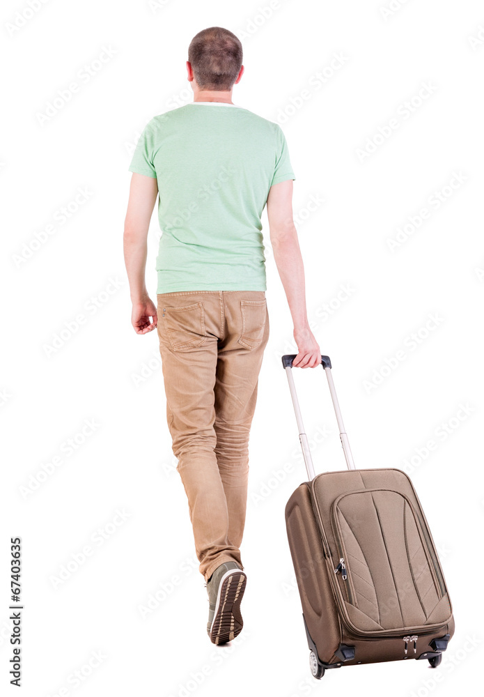 back view of walking  man  with suitcase.