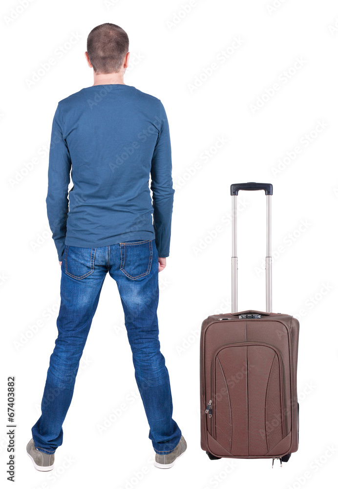 Back view of young man traveling with suitcas. Back view of young man traveling with suitcas.