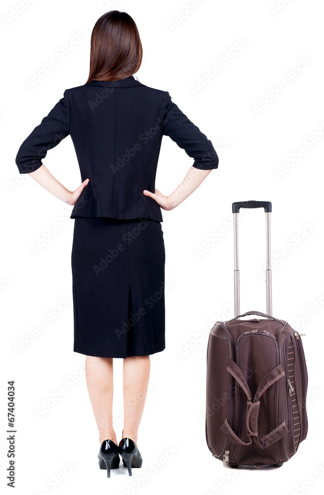 back view of thoughtful business woman traveling with suitcas. back view of thoughtful business woman traveling with suitcas.