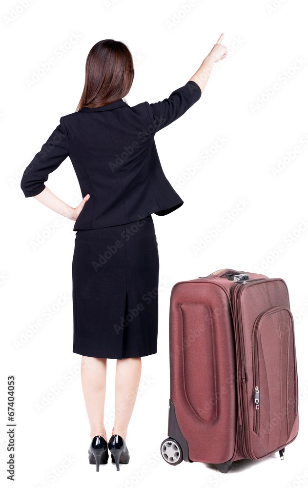 Back view of young brunette business woman traveling with suitca Back view of young brunette business woman traveling with suitca