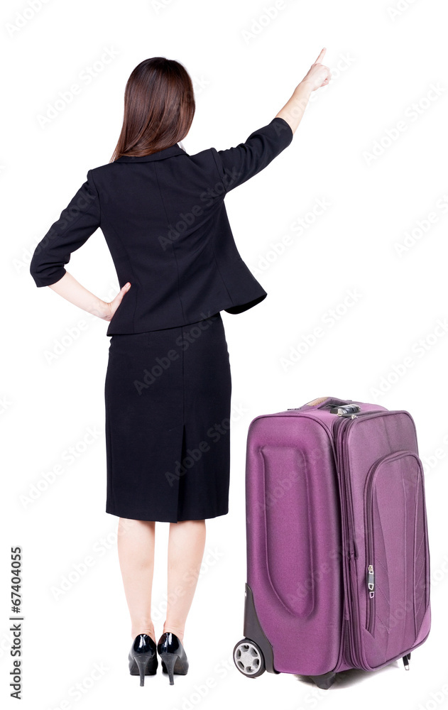 Back view of young brunette business woman traveling with suitca Back view of young brunette business woman traveling with suitca