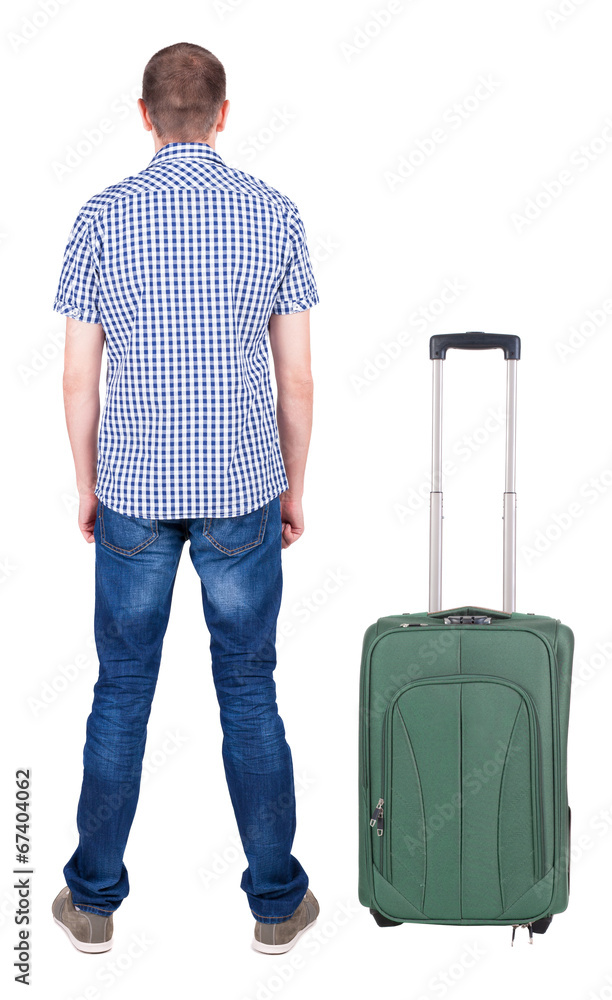 Back view of young man traveling with suitcas. Back view of young man traveling with suitcas.