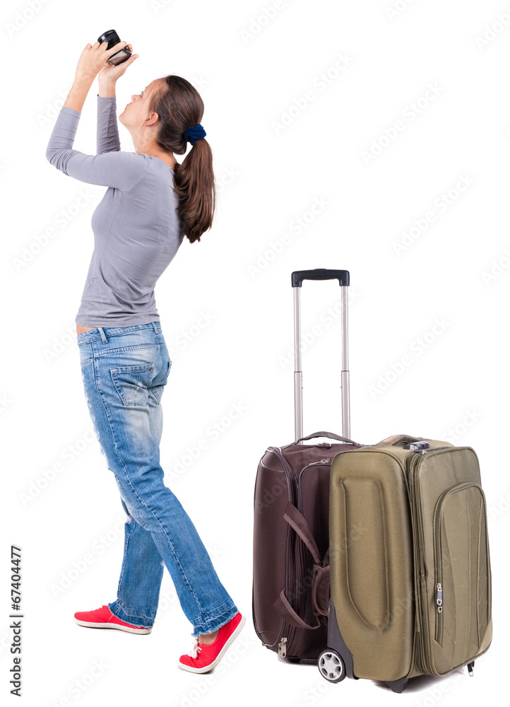 Back view of woman photographing traveling with suitcas. Back view of woman photographing traveling with suitcas.