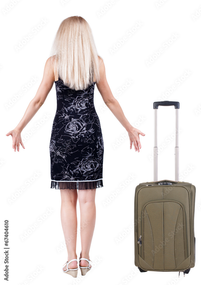 Back view of shocked woman traveling with suitcas . Back view of shocked woman traveling with suitcas .