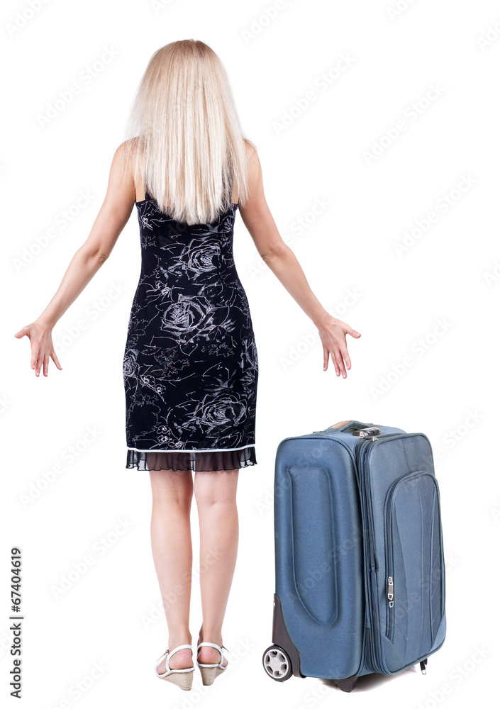 Back view of shocked woman traveling with suitcas . Back view of shocked woman traveling with suitcas .