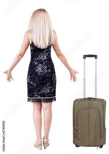 Back view of shocked woman traveling with suitcas .