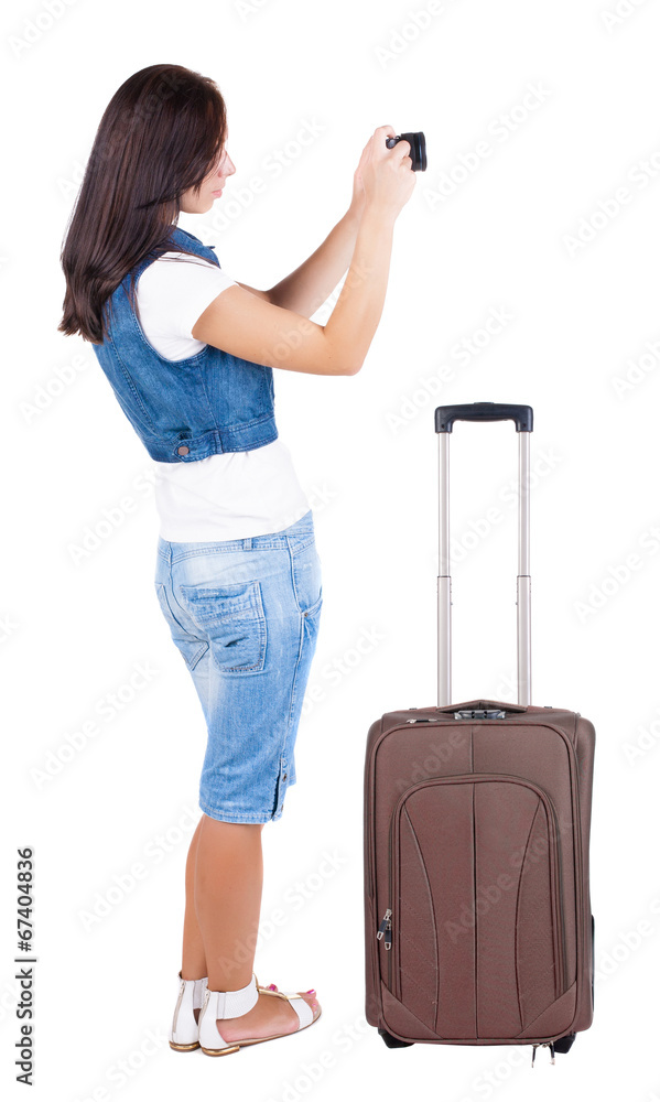 Back view of woman photographing traveling with suitcas. Back view of woman photographing traveling with suitcas.