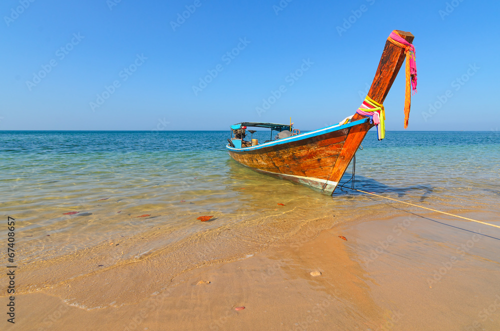 A long tail boat on a tropical island beach in thailand