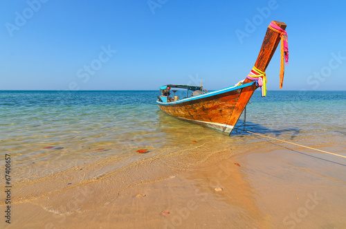 A long tail boat on a tropical island beach in thailand © brbphoto