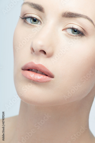 Closeup portrait of young beautiful green eyed woman