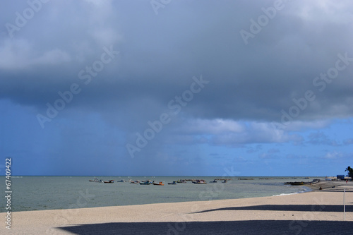 barcos no mar e sombra na areia photo