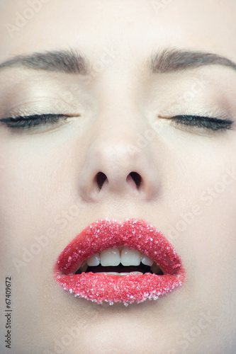 Portrait of sexual beautiful blonde with lips sprinkled sugar is