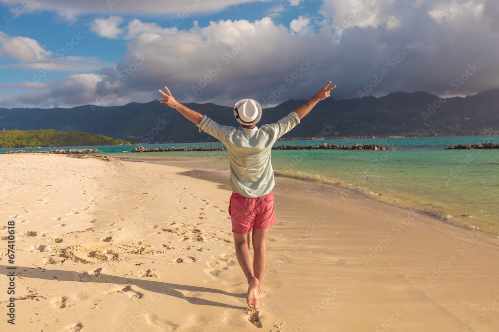 man walking on the beach and celebrates his joyous life man walking on the beach and celebrates his joyous life