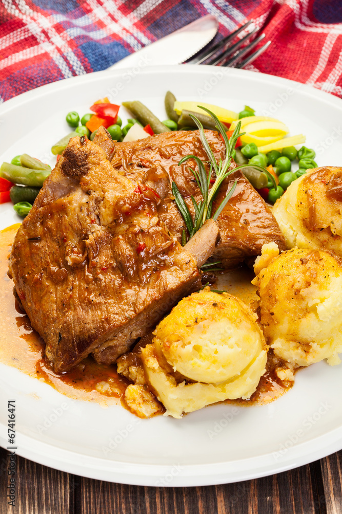 Pork spareribs served with mashed potatoes Pork spareribs served with mashed potatoes