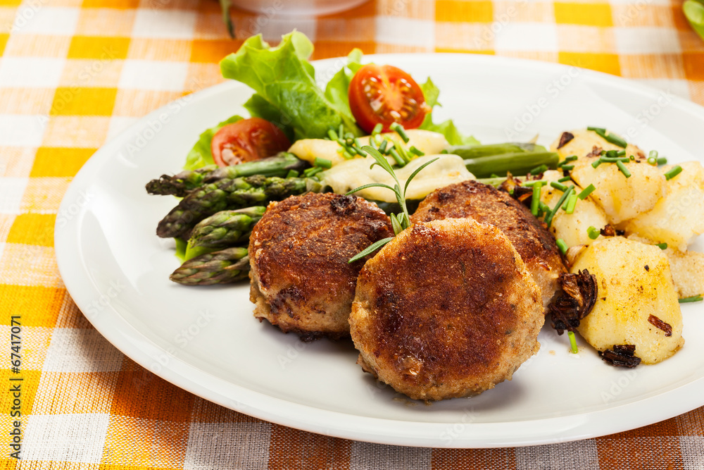 Meatballs served with boiled potatoes and asparagus Meatballs served with boiled potatoes and asparagus