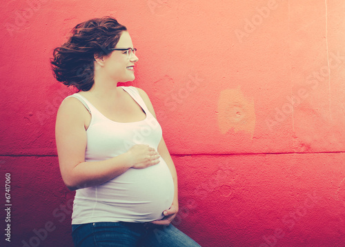 pregnant woman in front of a wall