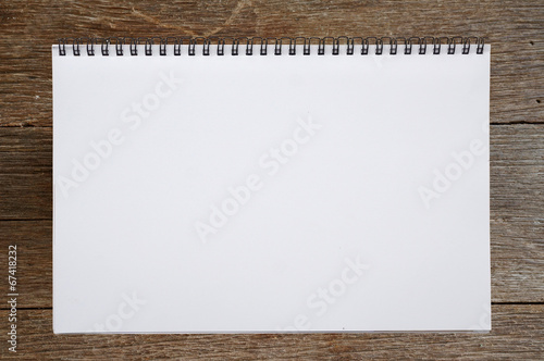 open sketchbook or notebook on wooden background