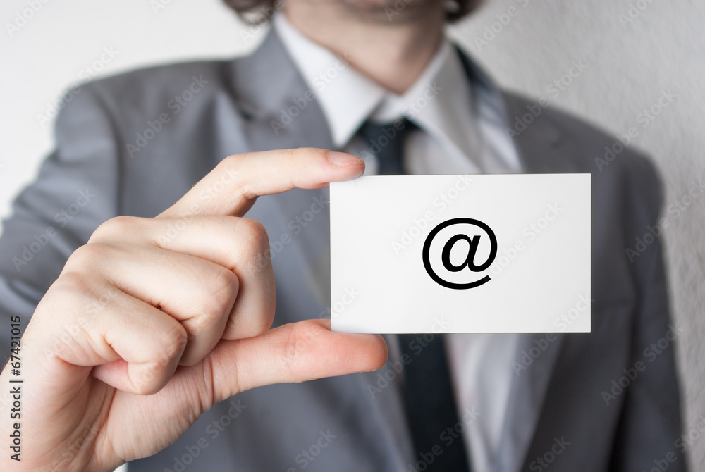 At symbol. Businessman showing business card At symbol. Businessman showing business card