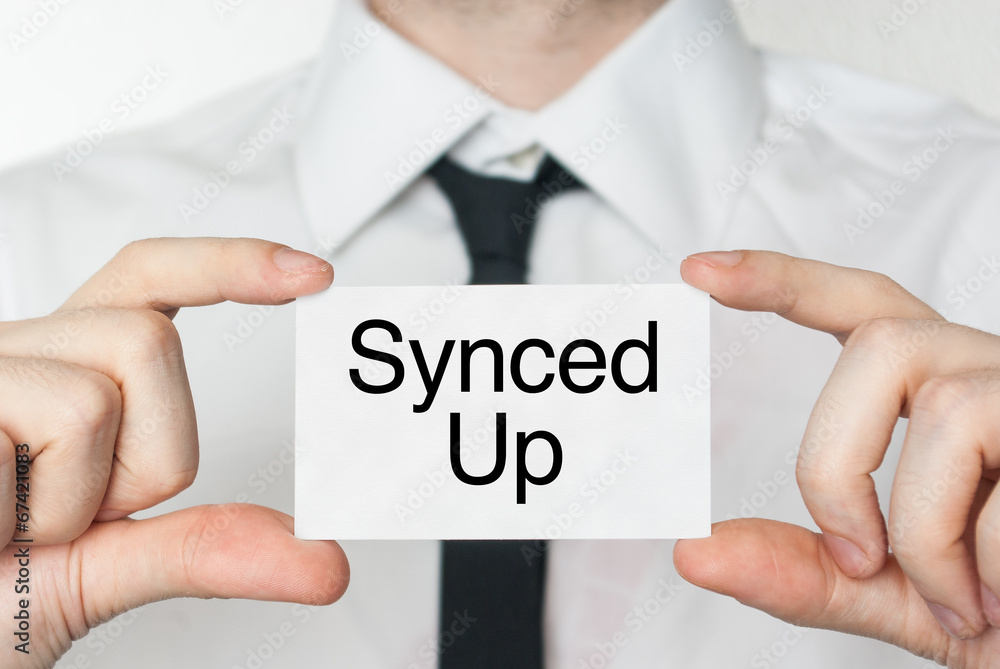 Synced Up. Businessman holding business card Synced Up. Businessman holding business card