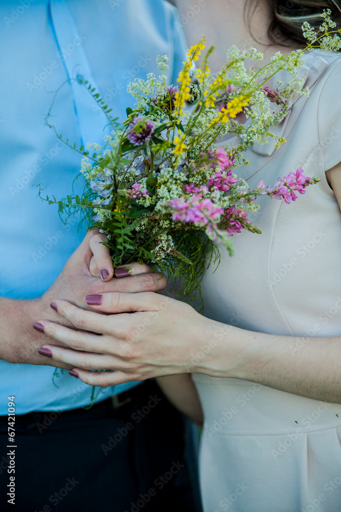 wedding: Bride and groom holding hands with bouquet wedding: Bride and groom holding hands with bouquet