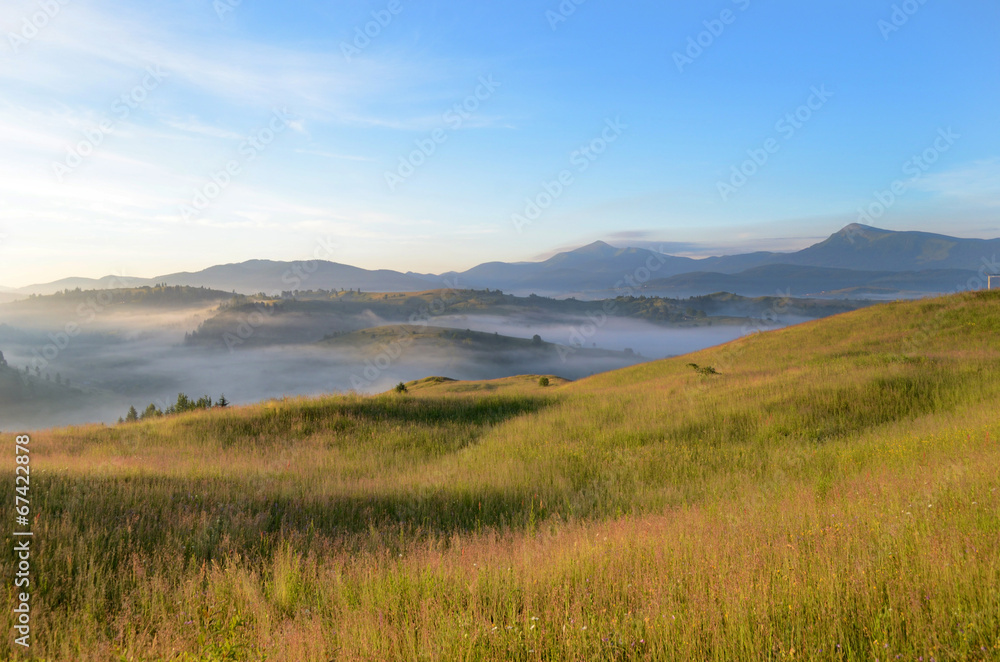 Magic landscape at sunrise in the mountains in the fog Magic landscape at sunrise in the mountains in the fog