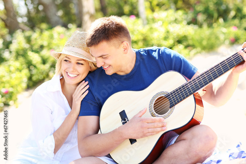 Romantic couple and guitar on the beach