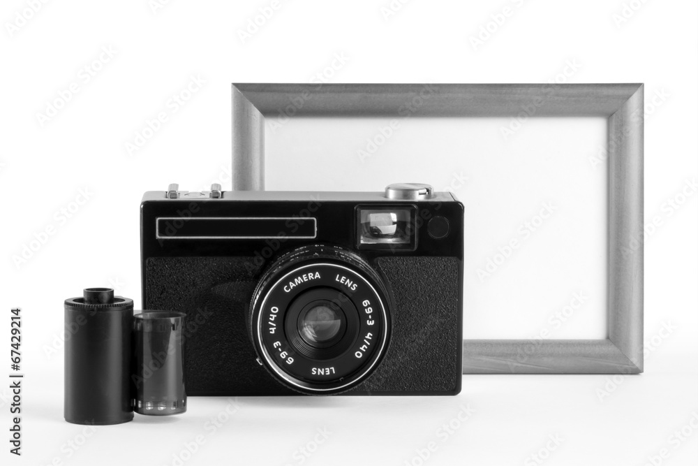 Old-fashioned film camera, film cassette and blank photoframe Old-fashioned film camera, film cassette and blank photoframe