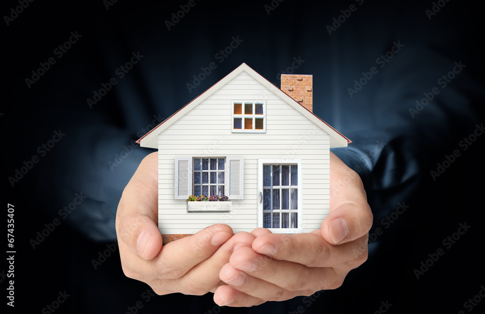 holding house representing home ownership