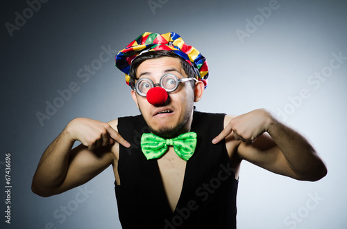 Funny clown against the dark background