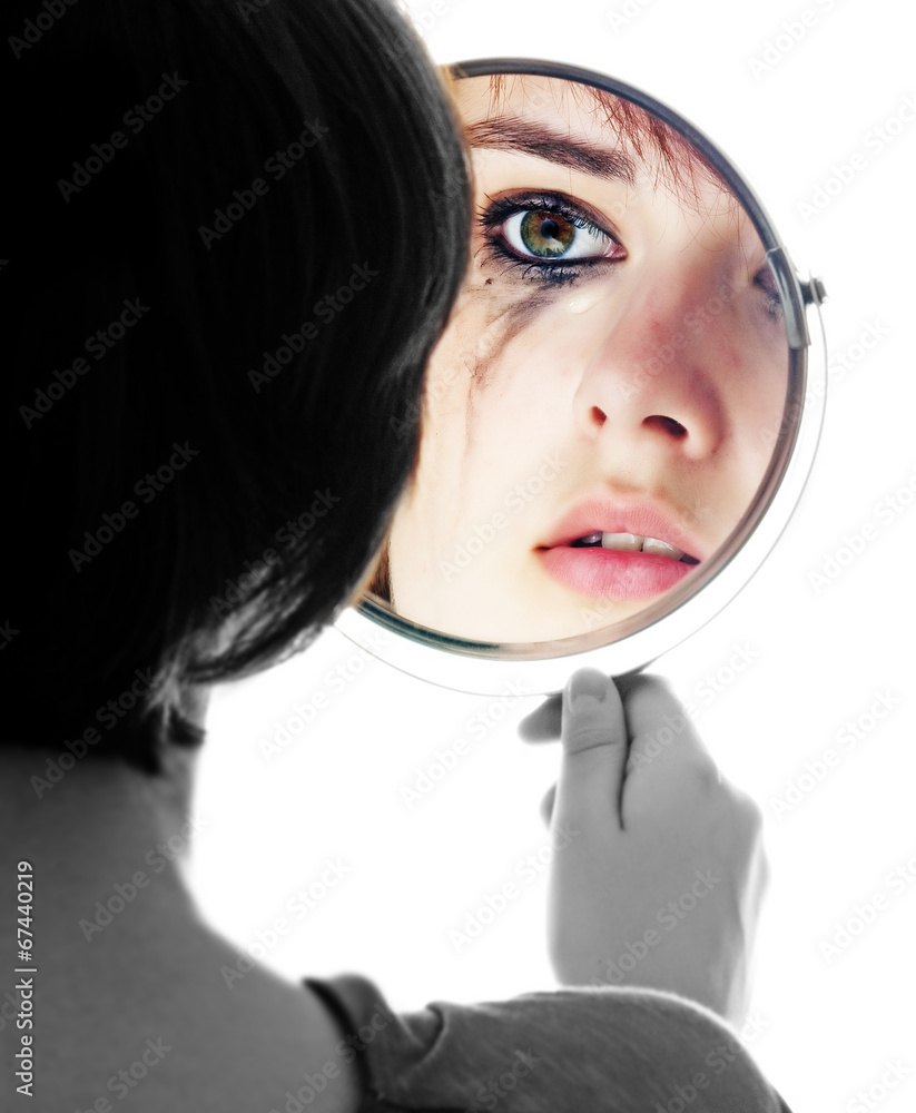 young girl looking in the mirror and crying sensitive eyes.. Stock