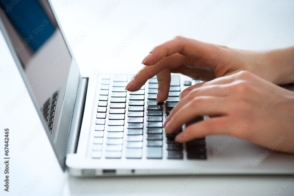 Closeup of businesswoman typing on laptop computer Closeup of businesswoman typing on laptop computer