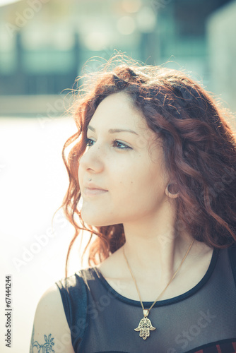 young beautiful hipster woman with red curly hair