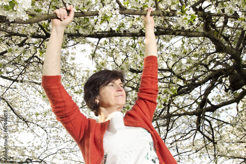 Woman is recovering under blooming cherry tree old photo