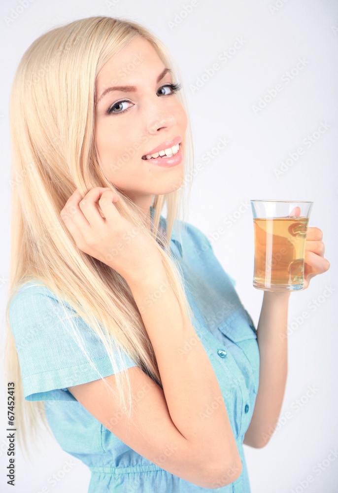 Young beautiful woman with cup of tea isolated on white Young beautiful woman with cup of tea isolated on white