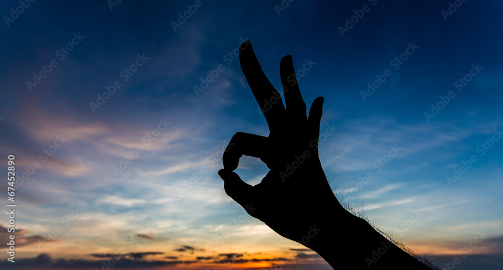OK shape hand silhouette in sky