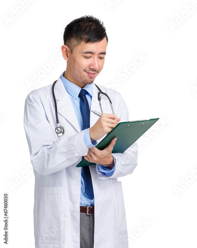 Asian male doctor write on clipboard