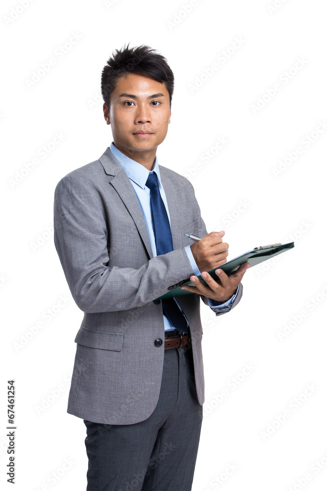 Asian businessman write on clipboard Asian businessman write on clipboard