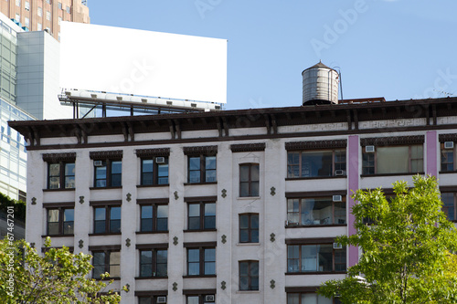Big, white, blank, billboard on the red brick building.