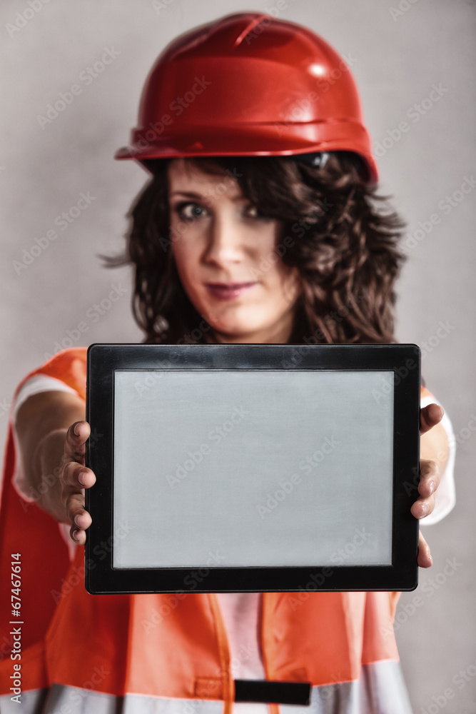 Sexy girl in safety helmet showing tablet Sexy girl in safety helmet showing tablet