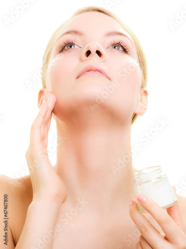 Skin care. Girl applying moisturizing cream