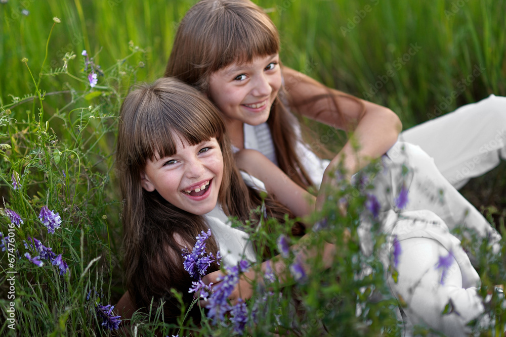 Portrait of two young girlfriends with flowers Portrait of two young girlfriends with flowers