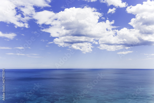 blue cloudy sky over the blue sea